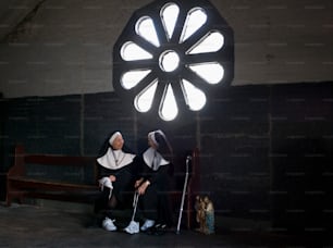 a nun and a nun sitting on a bench