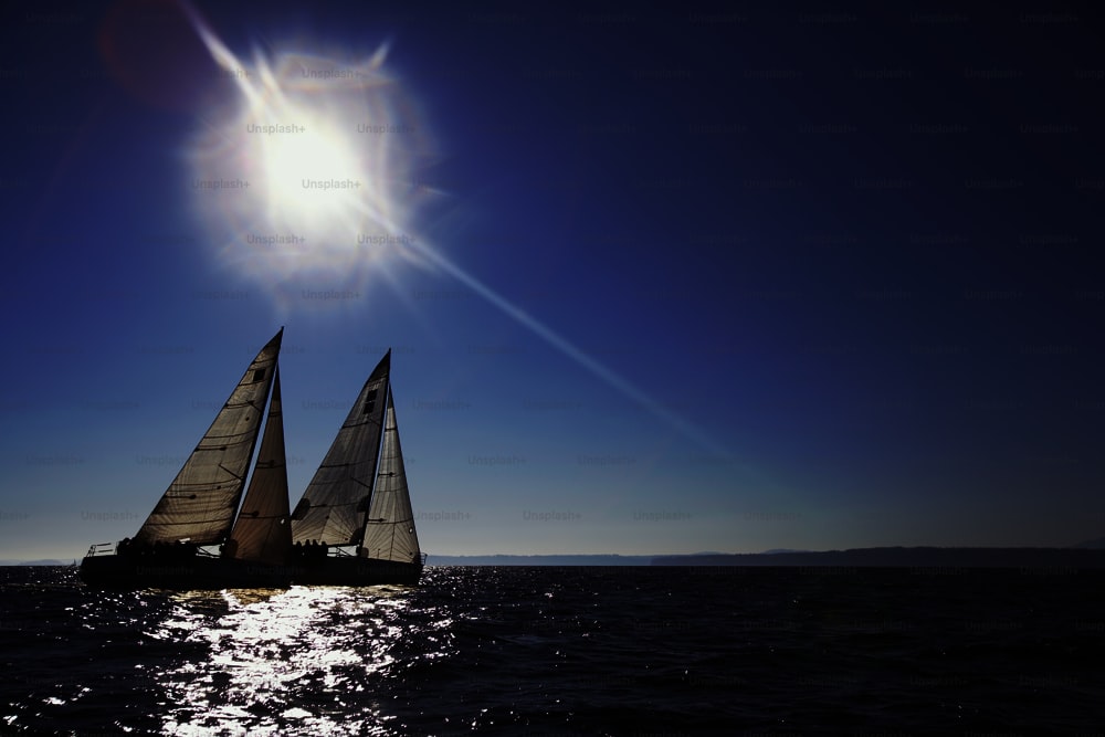 a sailboat sailing in the ocean on a sunny day