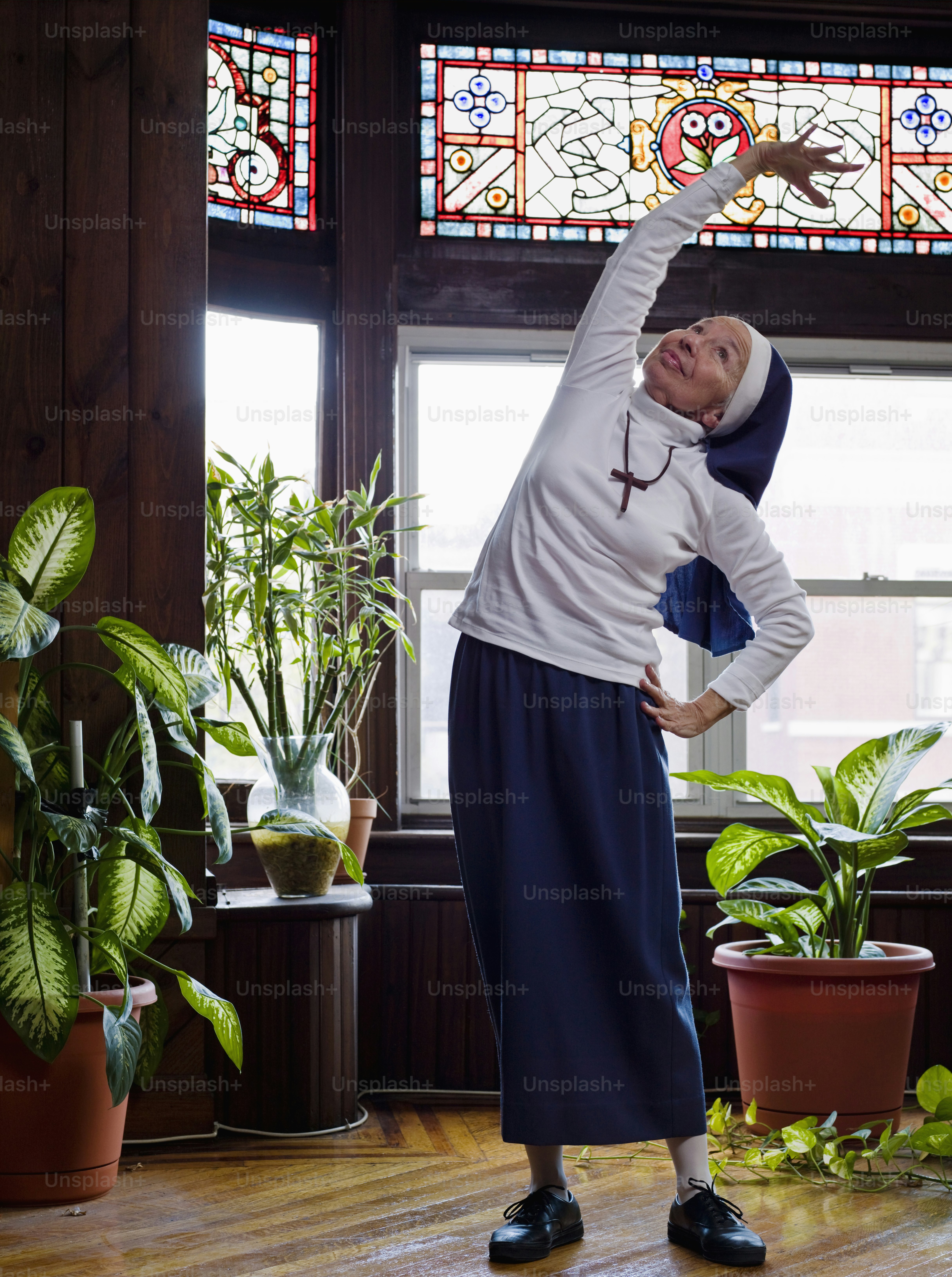 a woman standing in front of a stained glass window