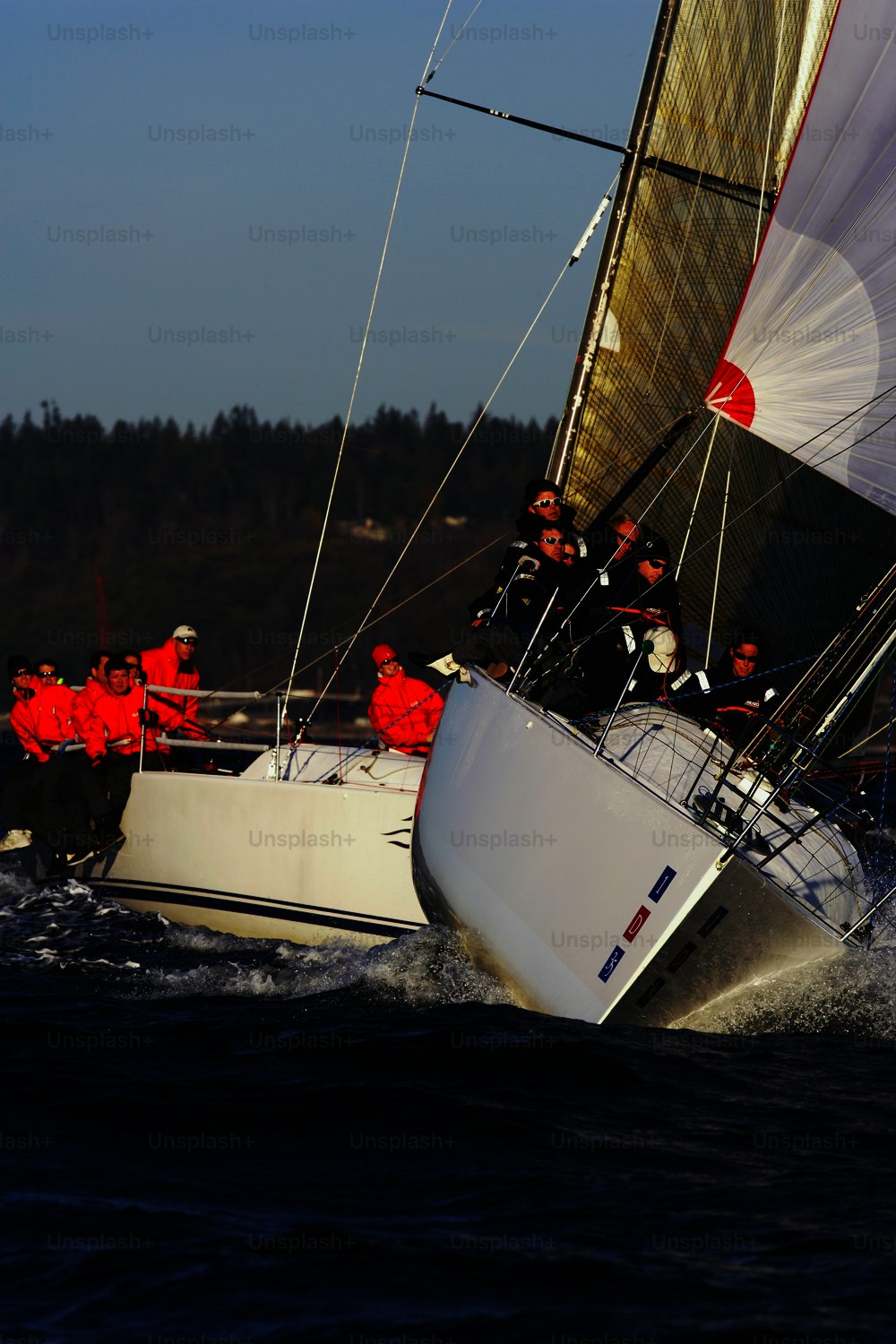 a group of people riding on the back of a sailboat