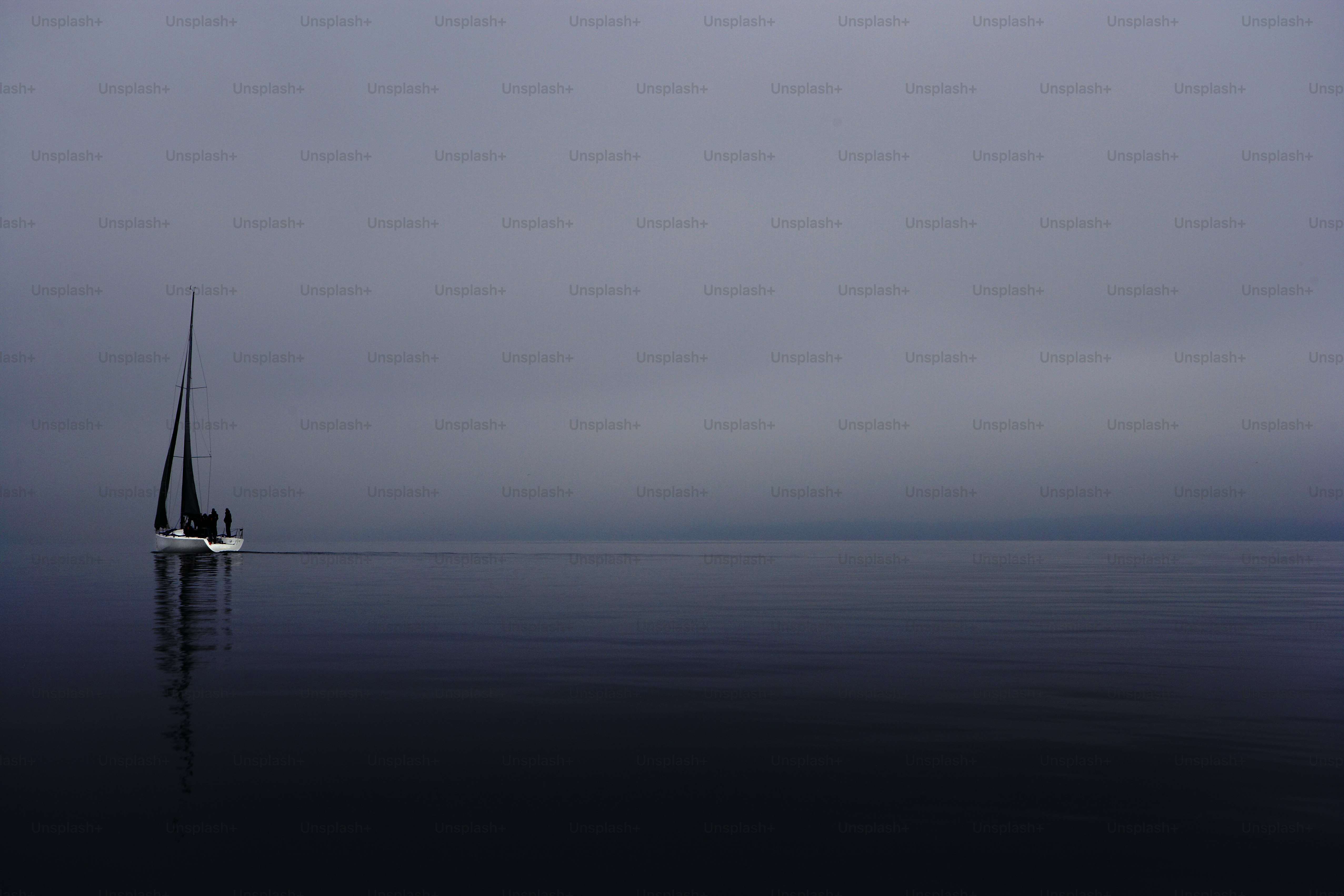 A sailboat in the middle of the ocean on a foggy day photo – Yacht