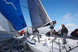 a group of people on a sailboat in the water