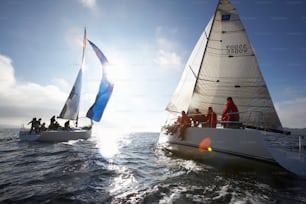 a group of people riding on top of a sail boat