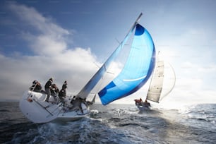 a group of people riding on the back of a sailboat