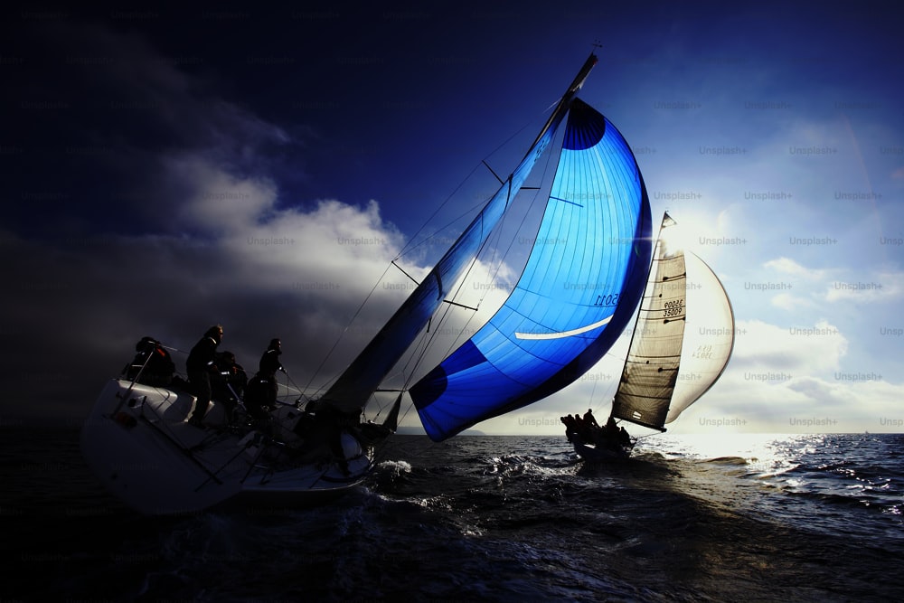 a group of people riding on the back of a sailboat