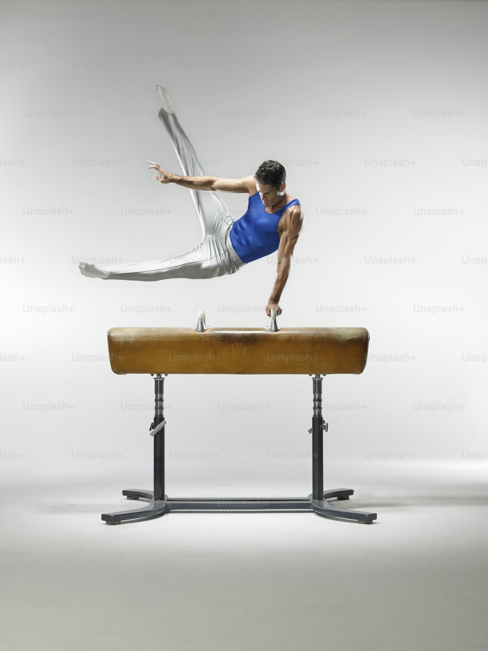 a man is doing a trick on a balance beam