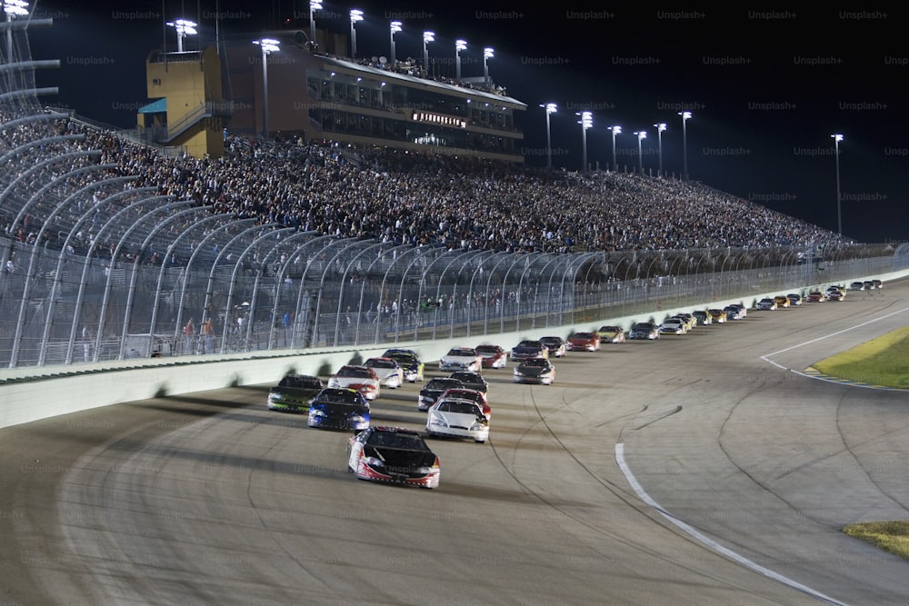 a group of cars driving down a race track