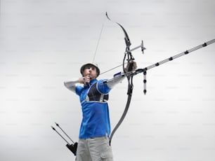 a man holding a bow and arrow in his hands