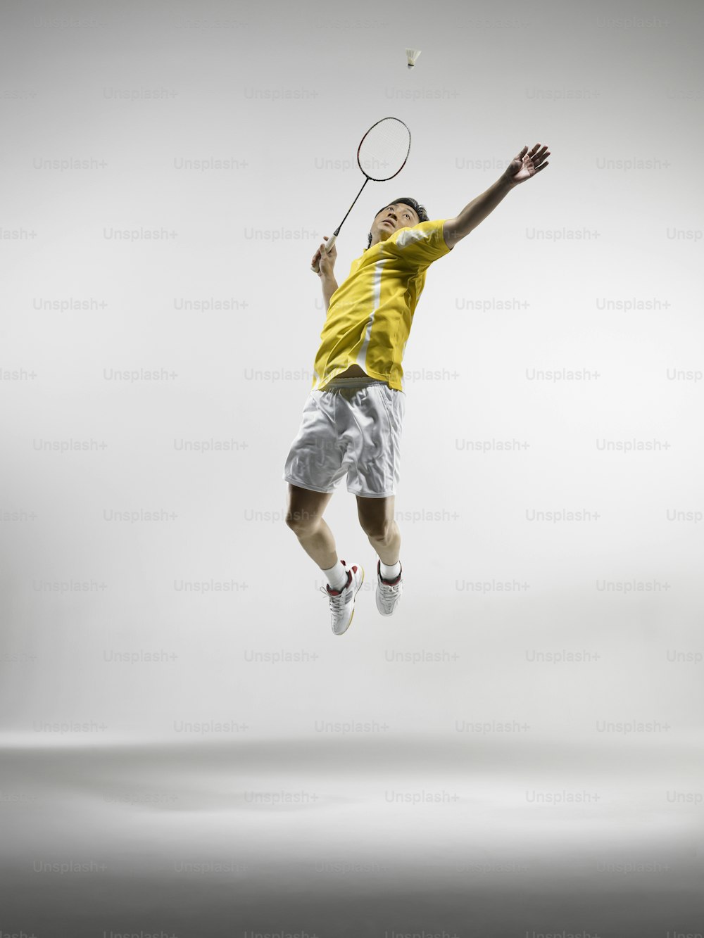 a man jumping in the air with a tennis racket