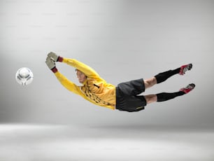 a man in a yellow shirt is kicking a soccer ball