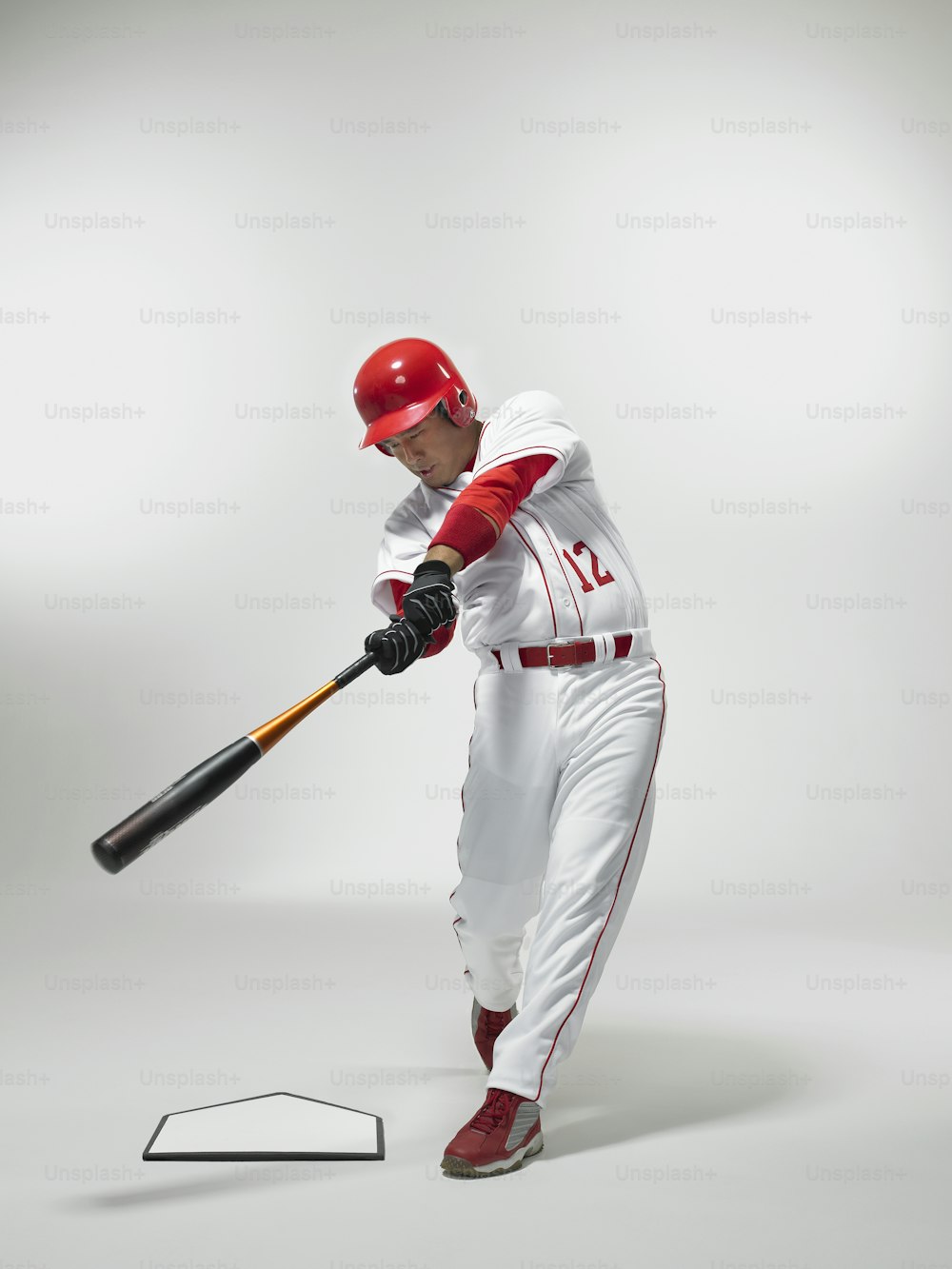 a man in a baseball uniform swinging a bat