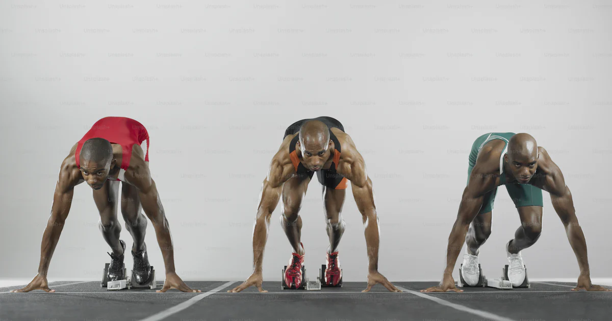 3 Men Racing A group of three men standing on top of a race track photo – Start line ...