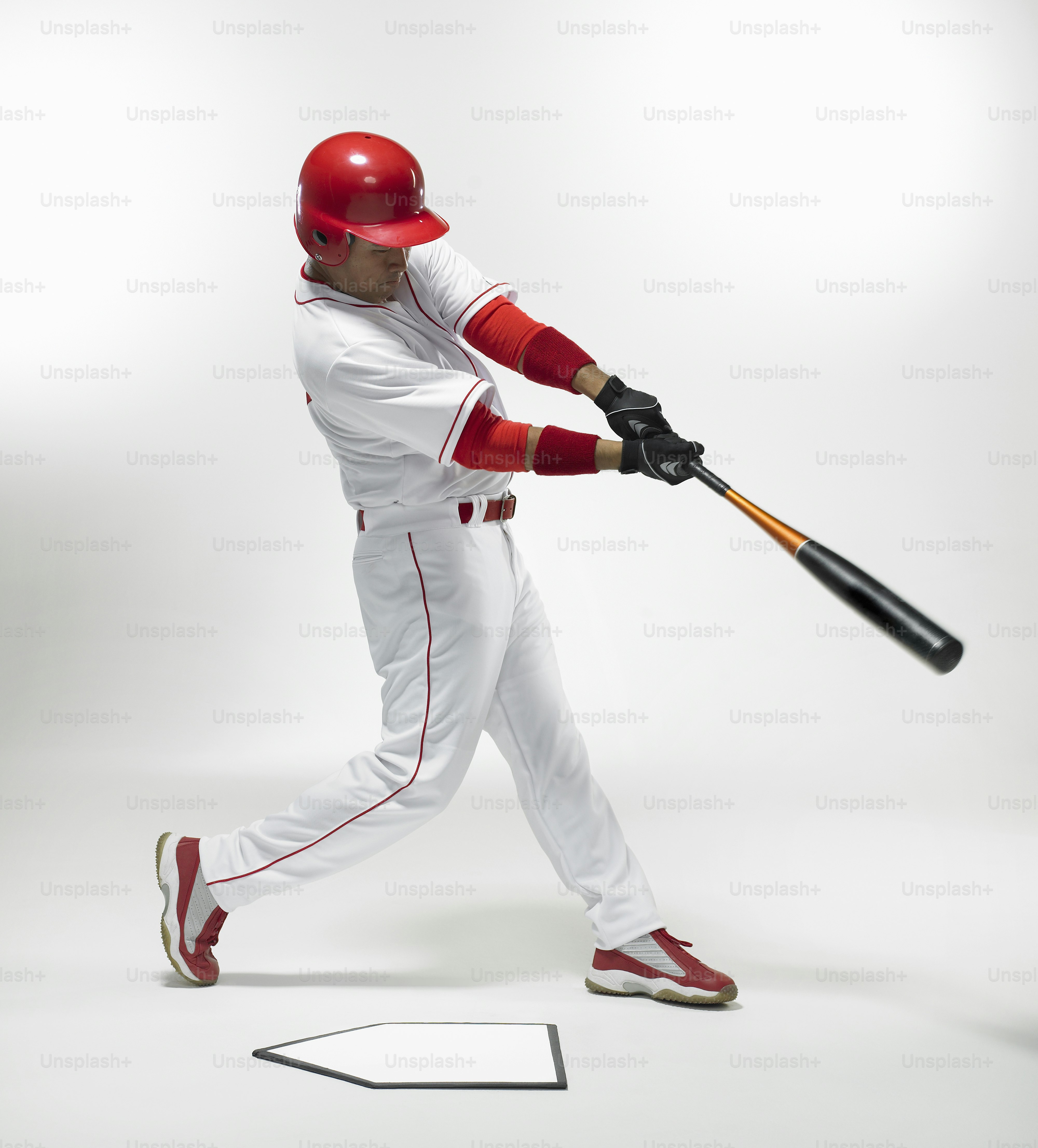 a man in a baseball uniform swinging a bat