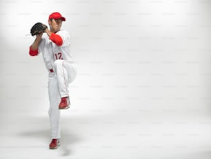 a man in a baseball uniform holding a baseball