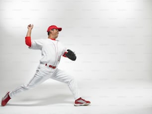 a man in a baseball uniform is throwing a baseball