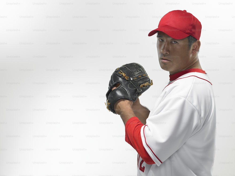 a man in a baseball uniform holding a catchers mitt