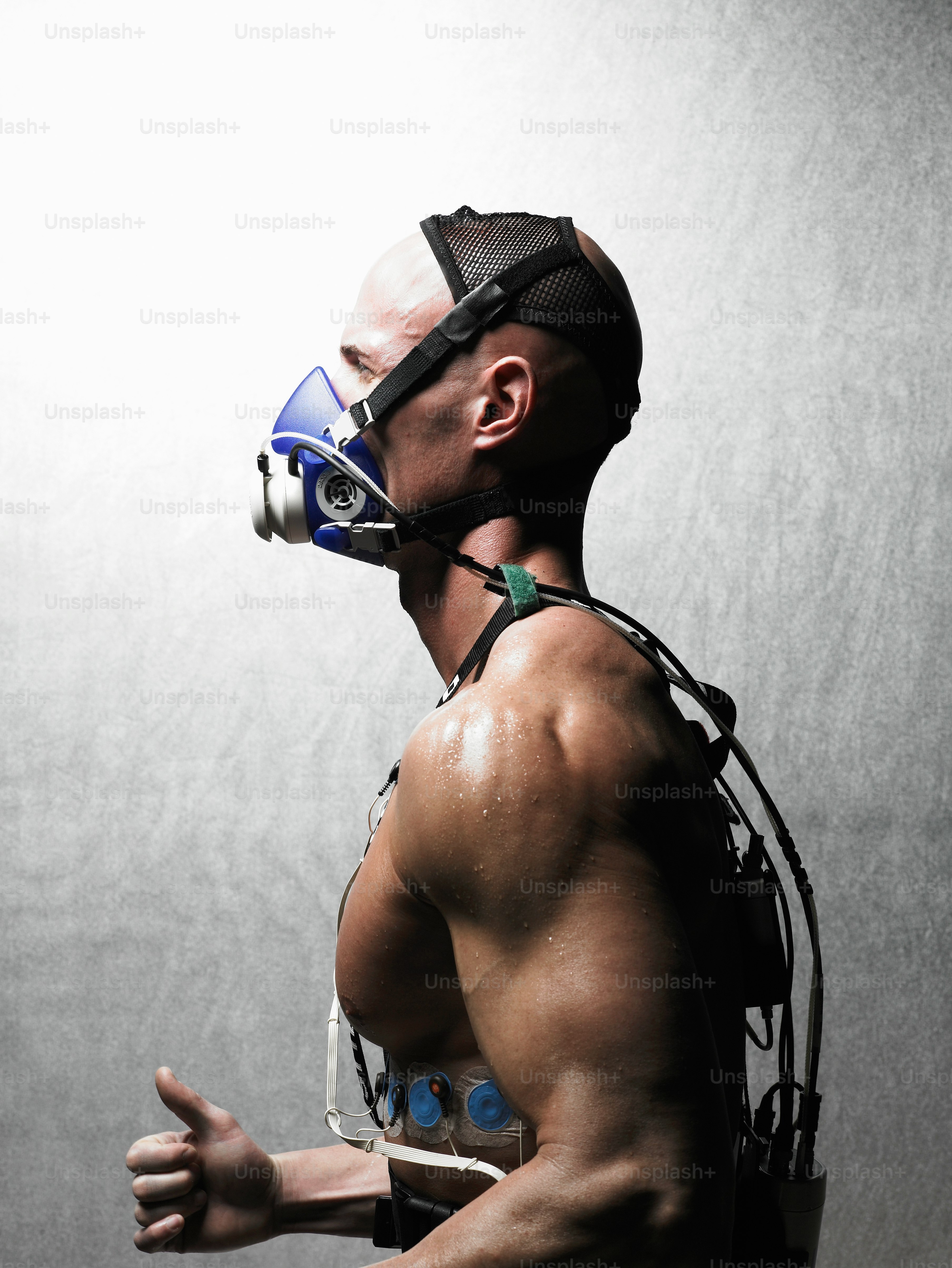A man wearing a gas mask and harness photo – Mask man Image on Unsplash