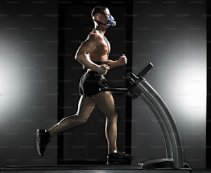 a man running on a treadmill in a dark room