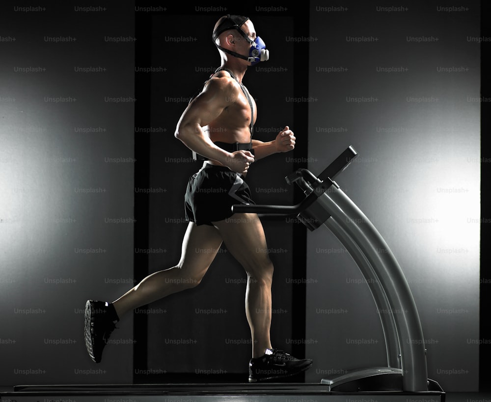a man running on a treadmill in a dark room