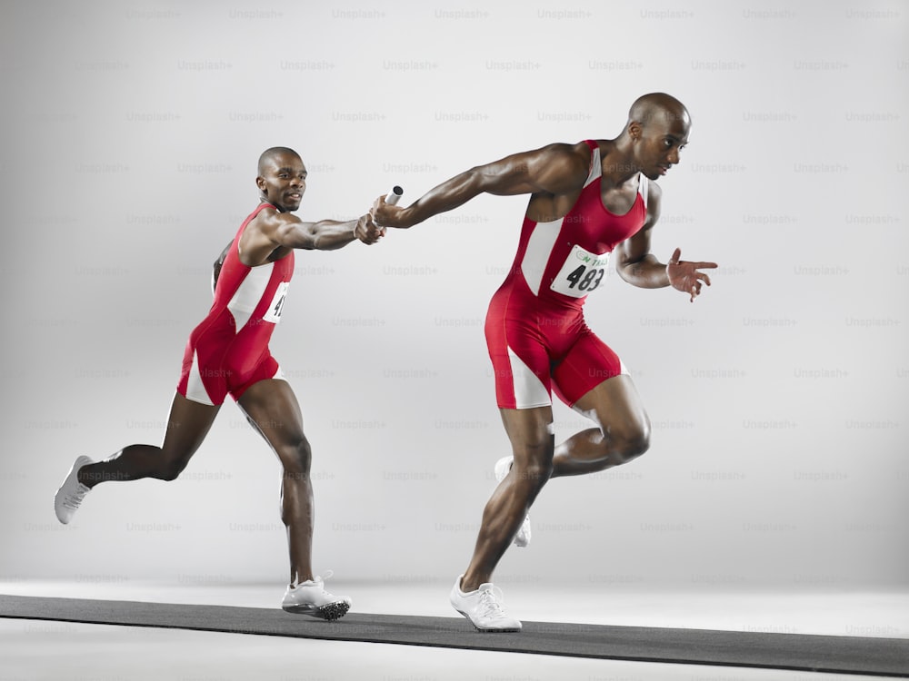 two men in red and white uniforms running