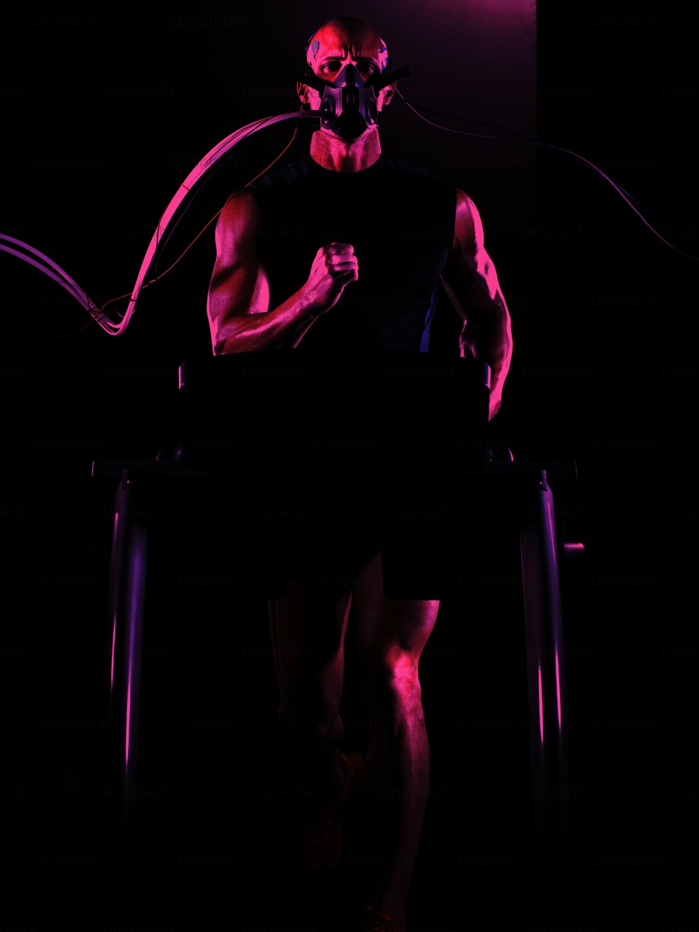 a man running on a treadmill with a mask on