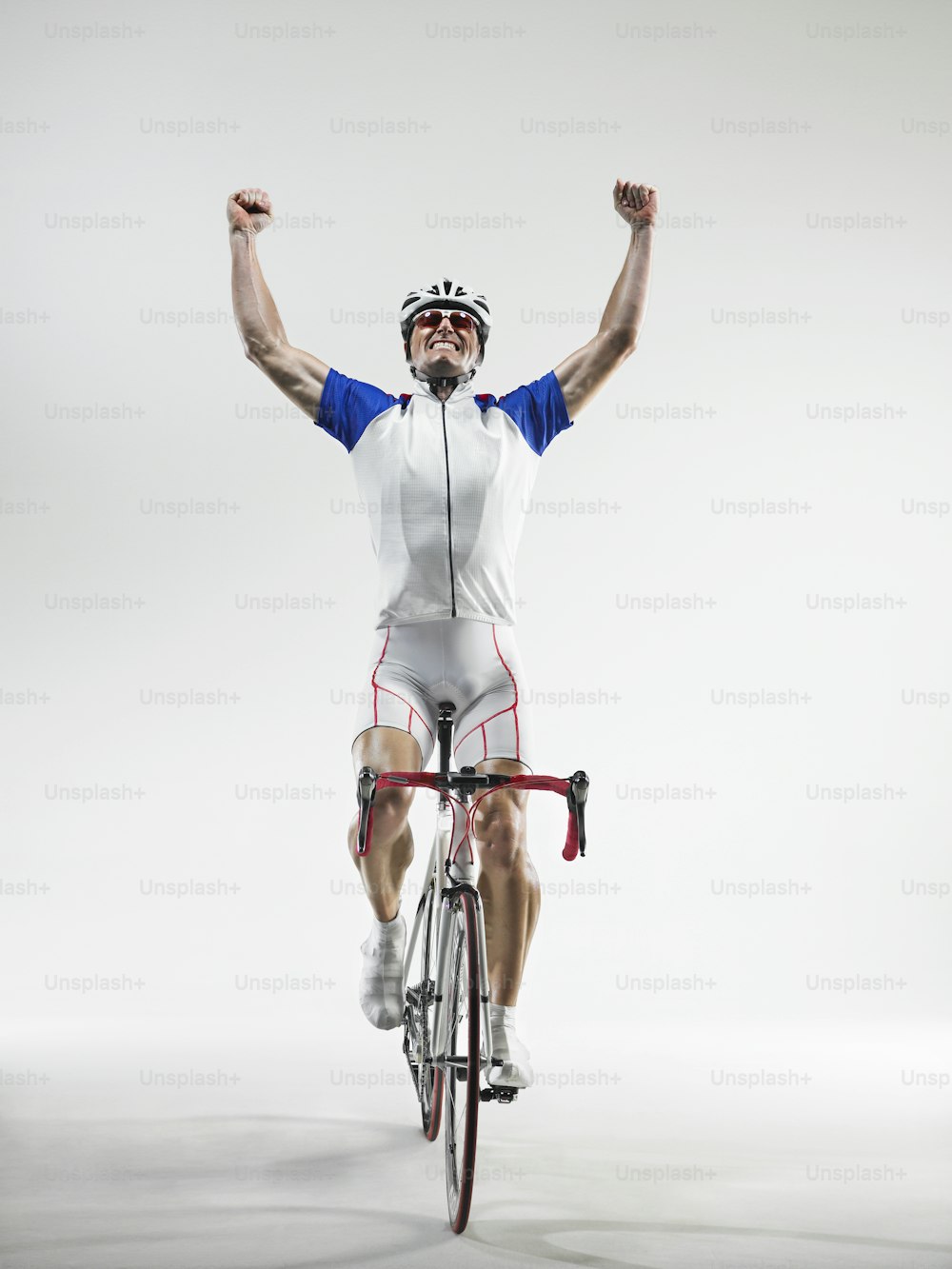 a man riding a bike with his arms in the air