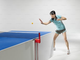 a woman hitting a tennis ball with a racquet