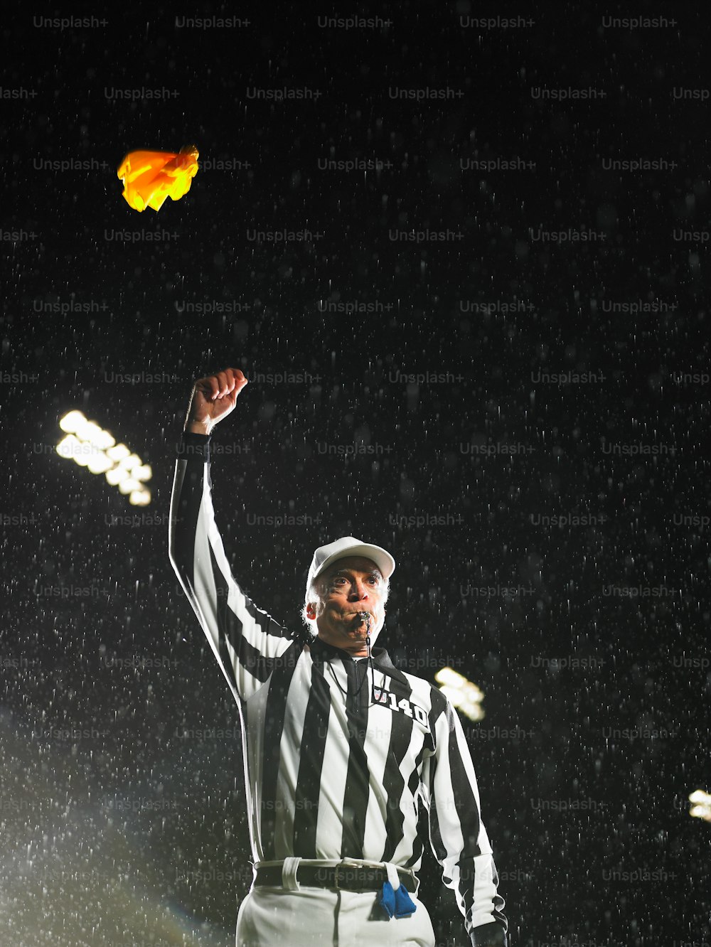 a referee throwing a yellow frisbee in the air
