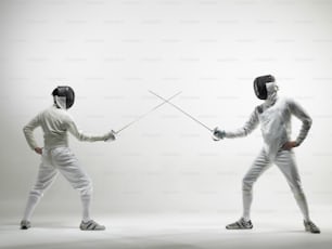 a couple of people in fencing gear holding swords