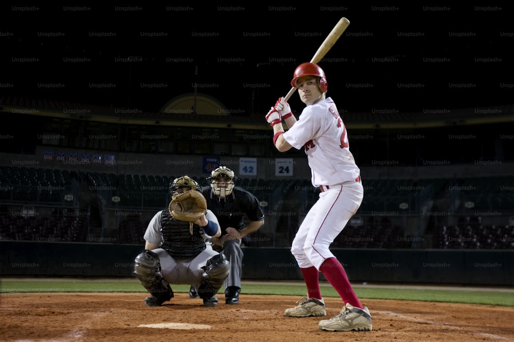 a baseball player holding a bat on top of a field
