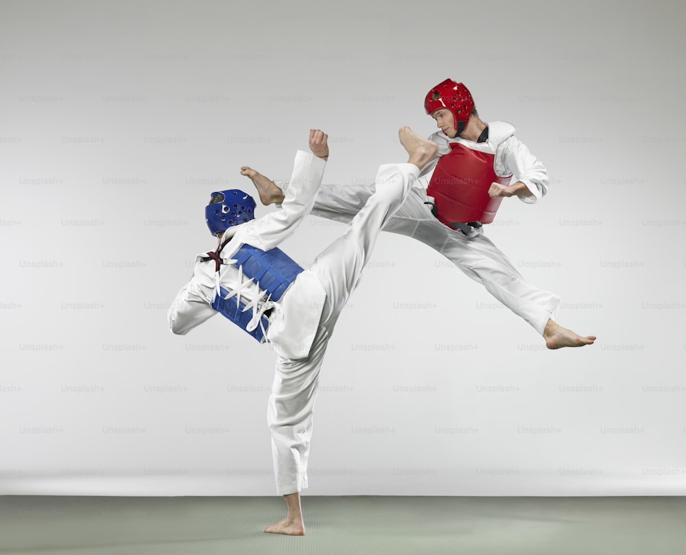 two people doing karate moves in a studio