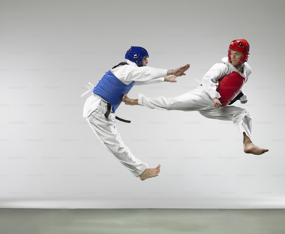 two people in the air doing karate moves