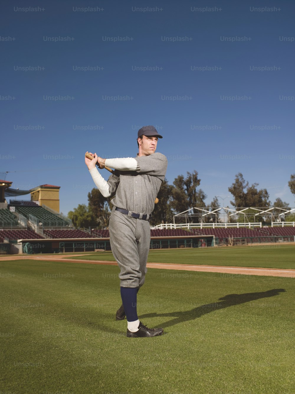 a man in a baseball uniform holding a bat