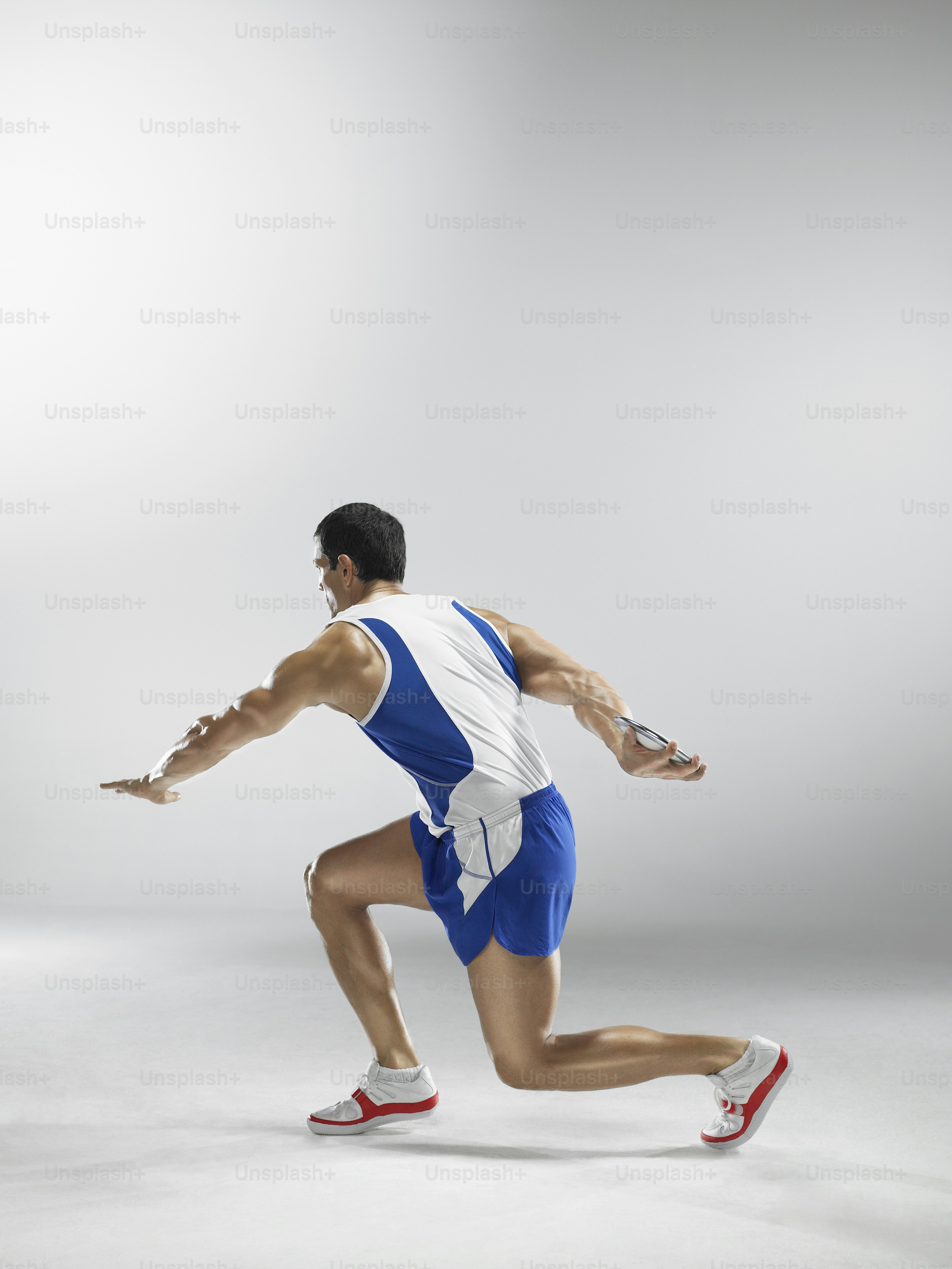 a man running with a tennis racket in his hand