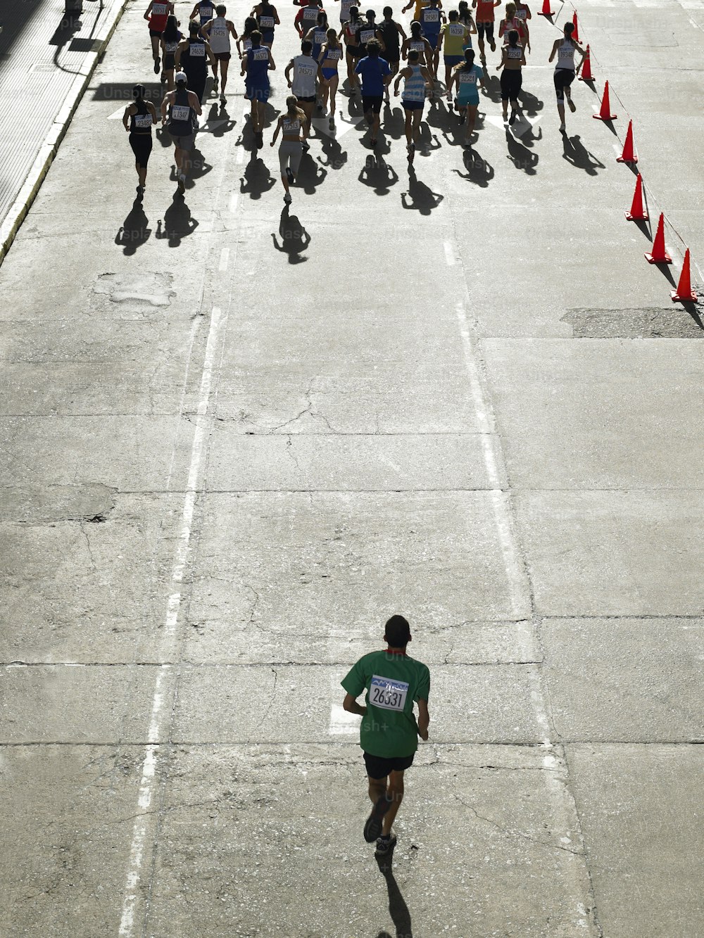 a group of people running down a street