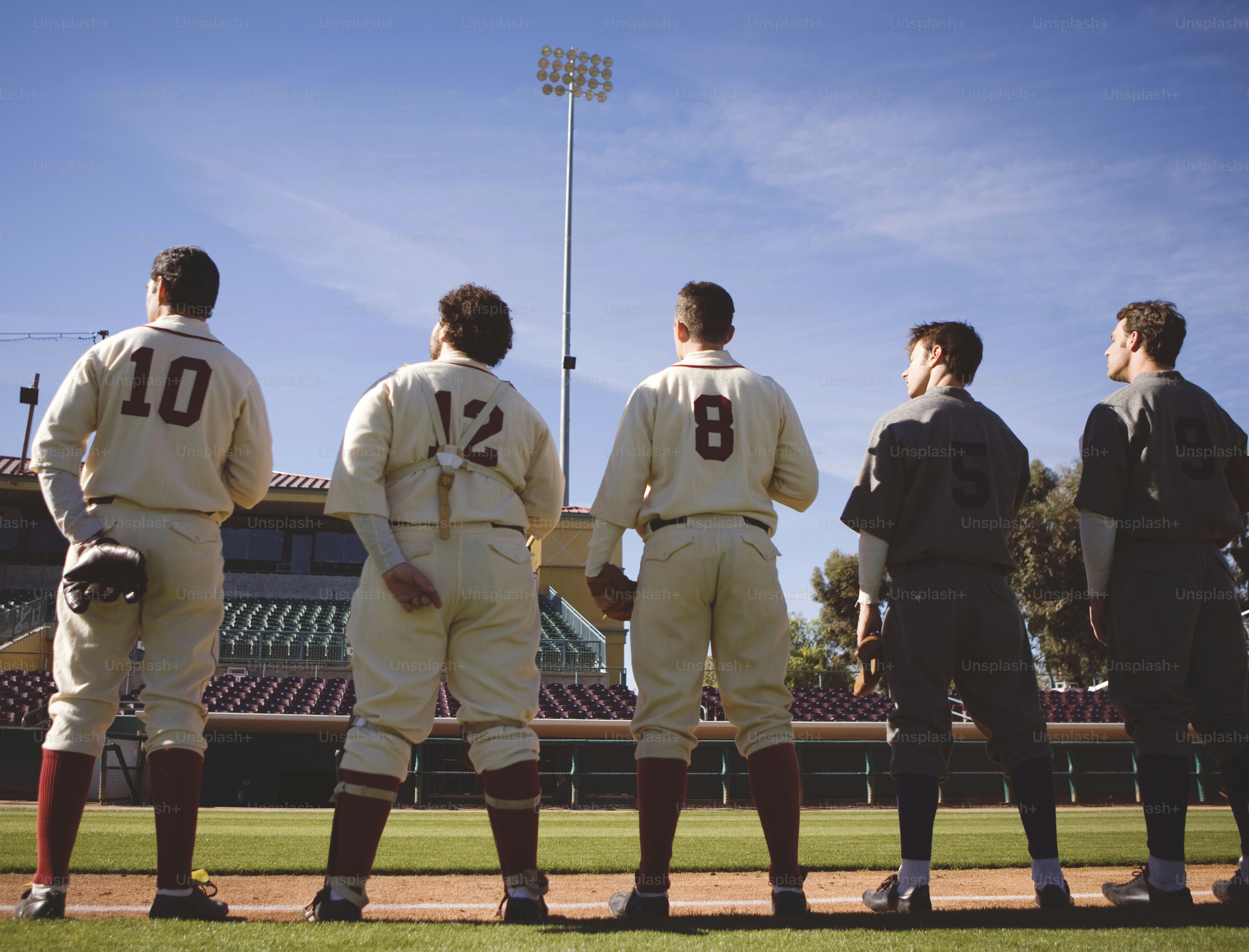 a group of men standing on top of a baseball field