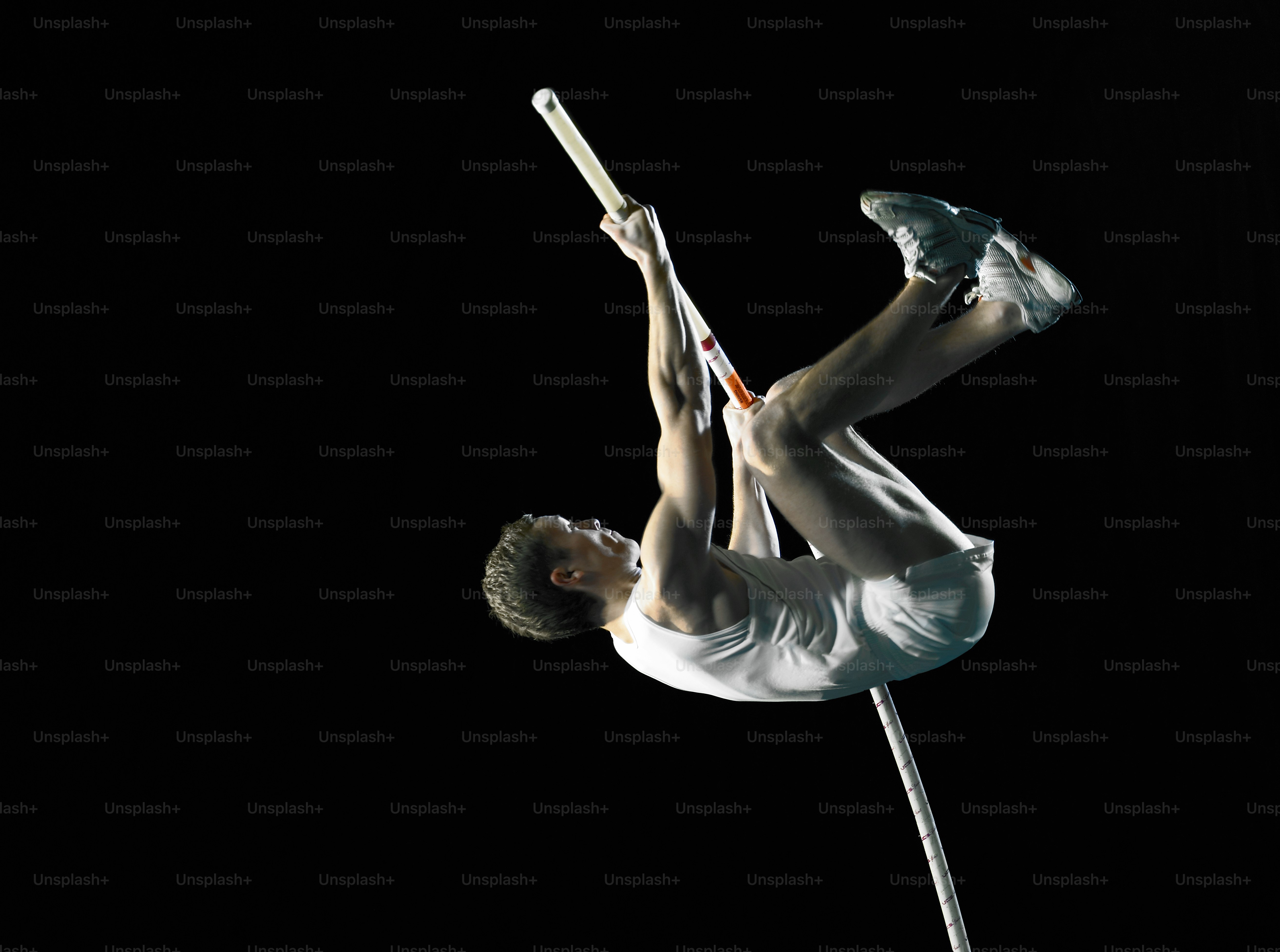 a man is doing a handstand on a pole