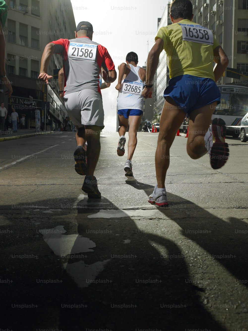 a group of men running down a street
