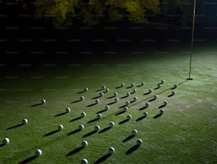 a group of golf balls on a green field