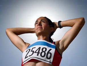 a woman with her hands behind her head