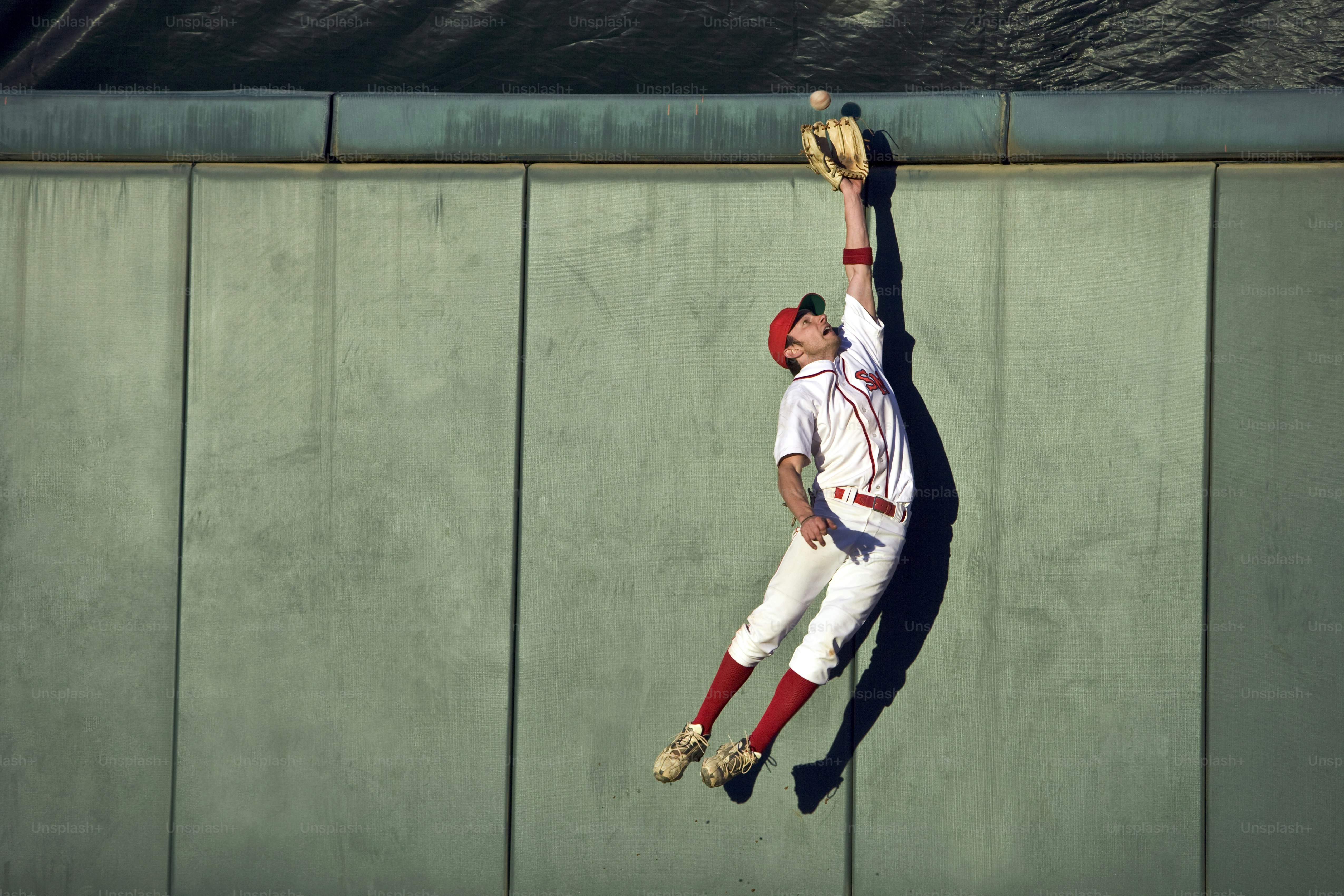 a baseball player catching a ball with his glove