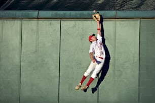 a baseball player catching a ball with his glove