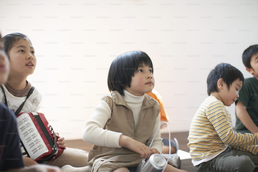 a group of young children sitting next to each other