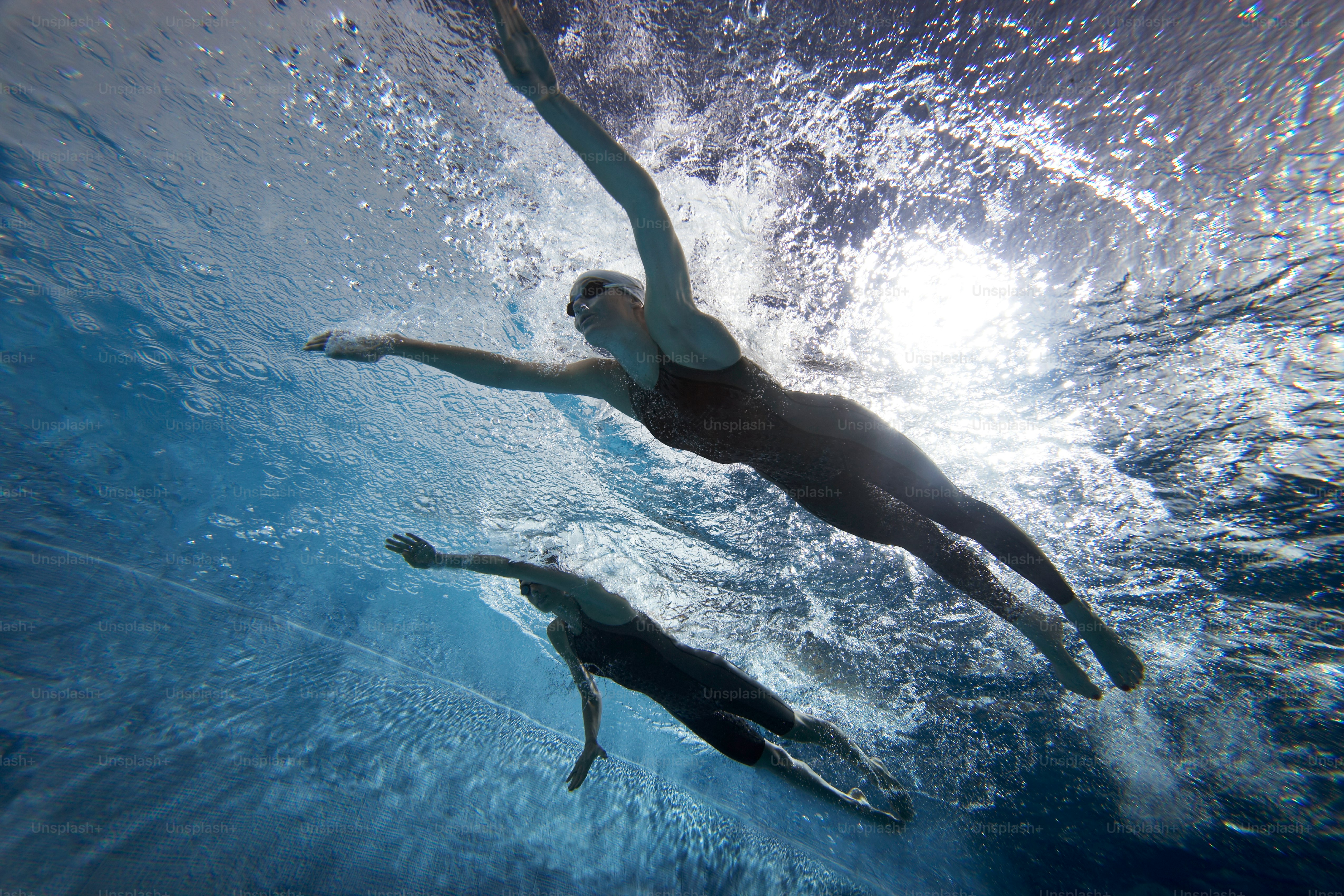 A woman swimming under water in a pool photo – Water sports Image on ...