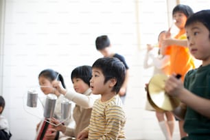 a group of young children playing musical instruments