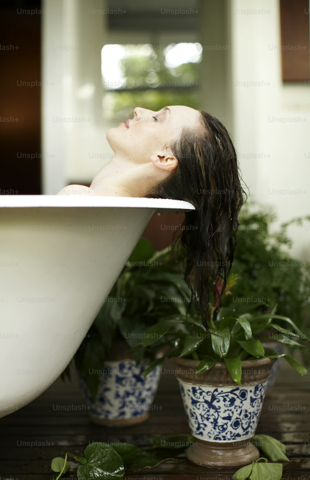 a woman taking a bath in a bathtub