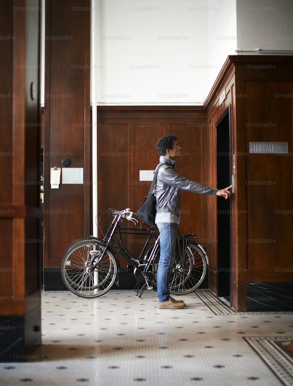 a person standing next to a bike in a room