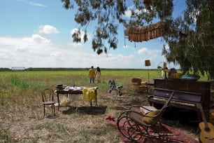 a group of people standing around a table in a field