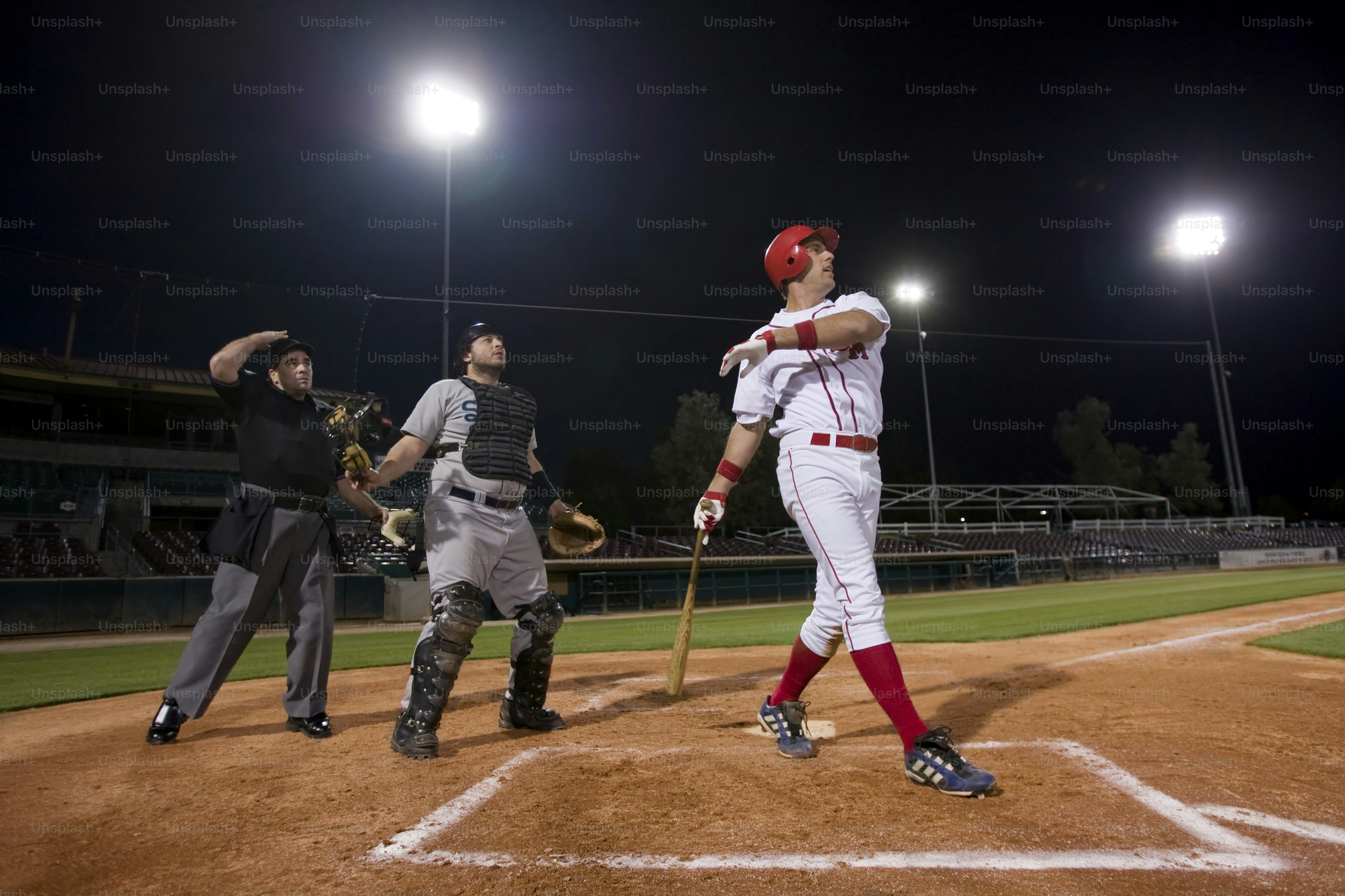 a baseball player holding a bat on top of a field