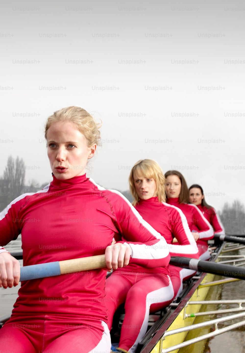 a group of women riding on the back of a boat